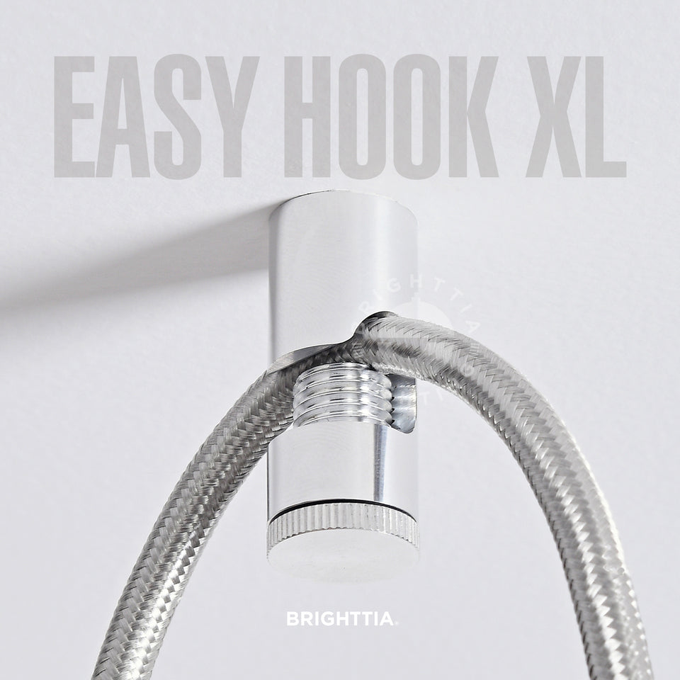 An aluminum easy hook XL mounted on white ceiling with a silver fabric cord hanging on it.