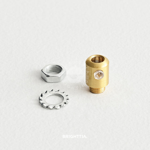 Cylinder brass cord grip with washer and nut displayed on white surface.