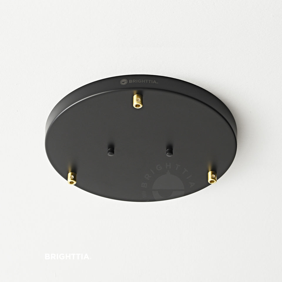 12in black 3-port ceiling canopy with gold cord grips mounted on white ceiling.