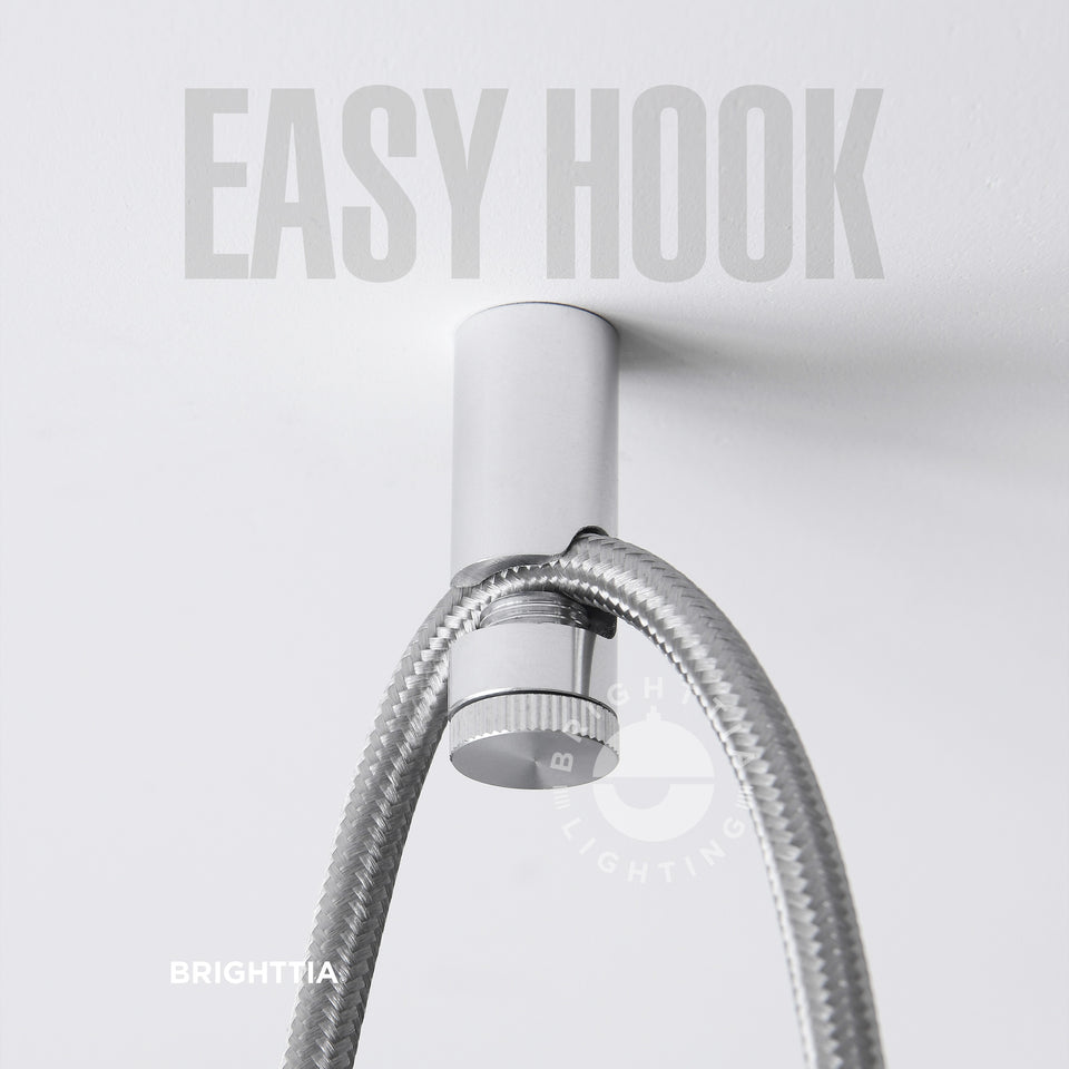 Brighttia Easy Hook in aluminum mounted on white ceiling with a silver fabric cord hanging on it.
